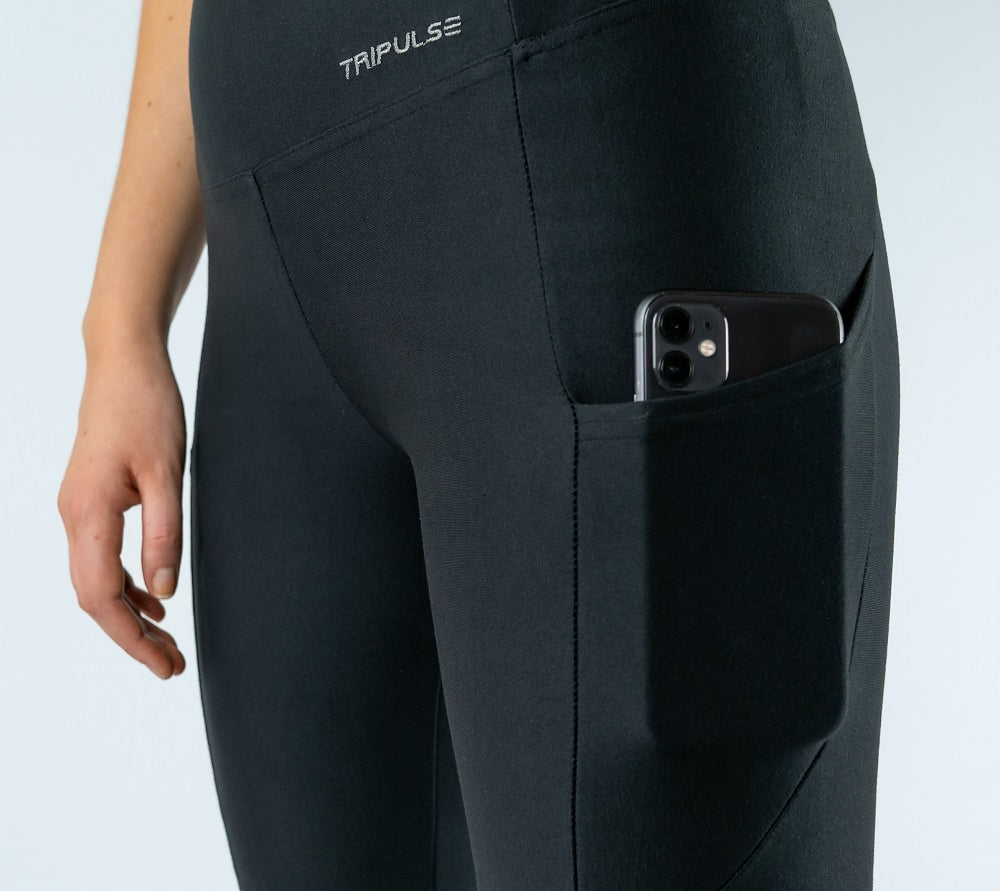 Close-up of black Tripulse leggings with a phone in the side pocket.