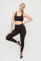 Woman wearing Tencel Sports Bra and Leggings Set in Terra Brown 