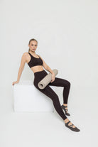 Woman wearing Tripulse sports bra and leggings set in terra brown