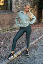 Woman wearing Tripulse Tencel Original Leggings in Moss Green outside